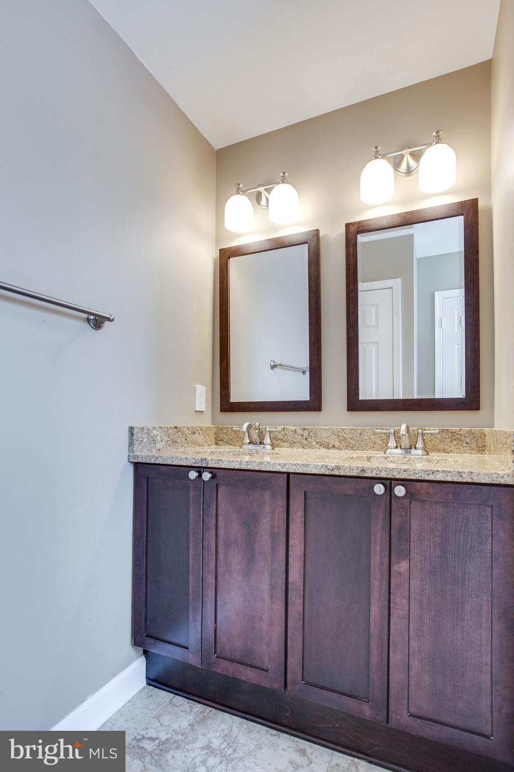 6121 Baldridge Circle Frederick, MD 21701 - Photo 34 of 60 a bathroom with a granite countertop sink and a mirror