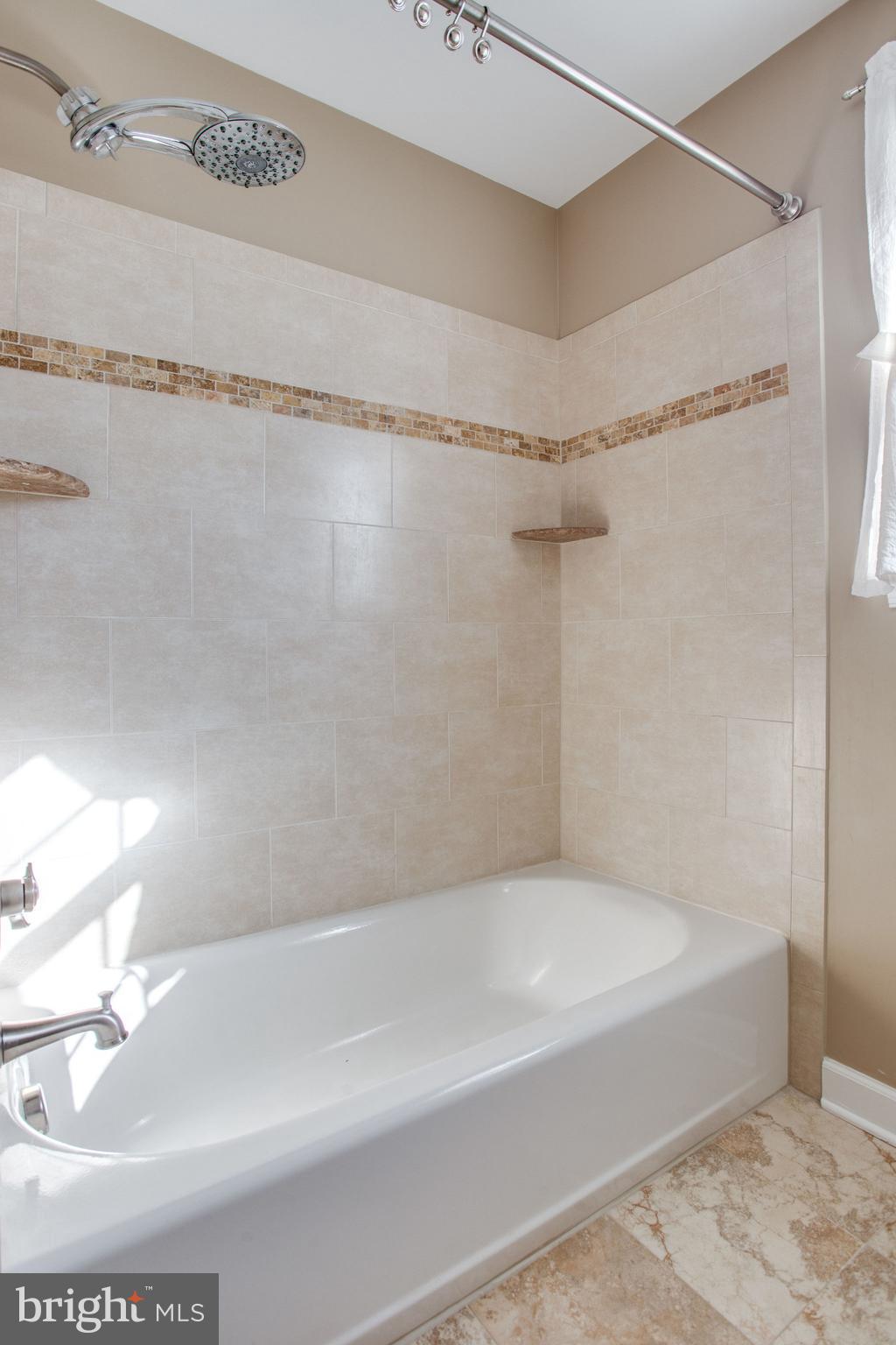 6121 Baldridge Circle Frederick, MD 21701 - Photo 35 of 60 a bathroom with a shower and a bath tub