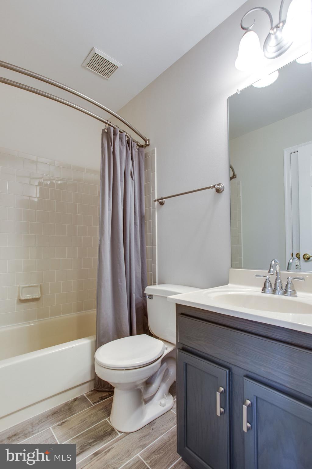 6121 Baldridge Circle Frederick, MD 21701 - Photo 37 of 60 a bathroom with a sink a toilet a mirror and shower