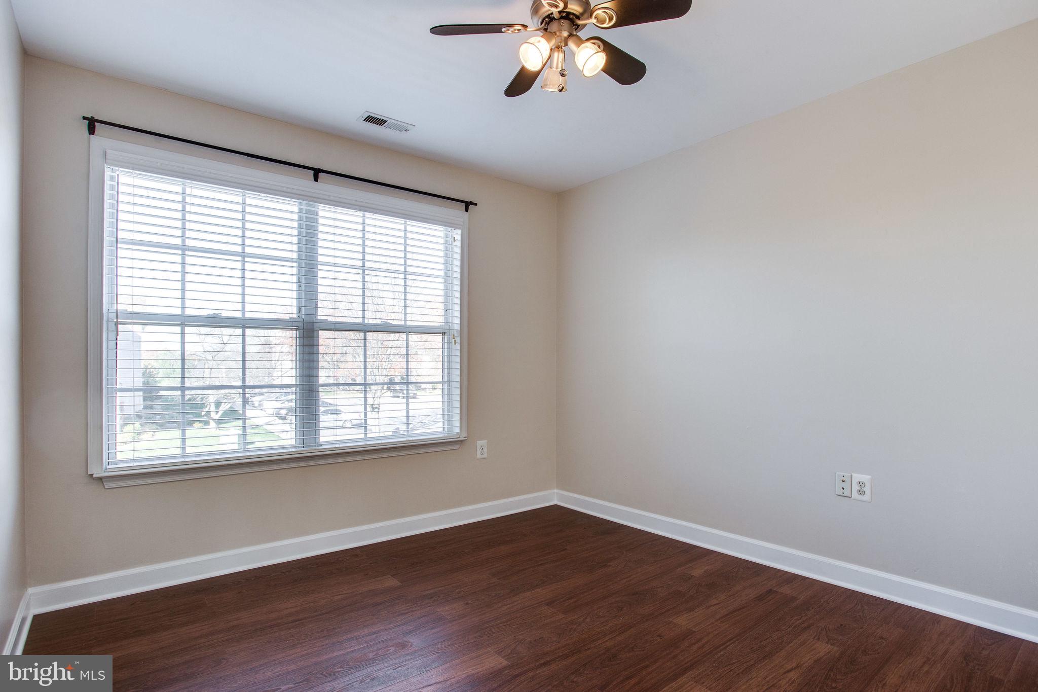 6121 Baldridge Circle Frederick, MD 21701 - Photo 38 of 60 a view of an empty room with wooden floor and a window