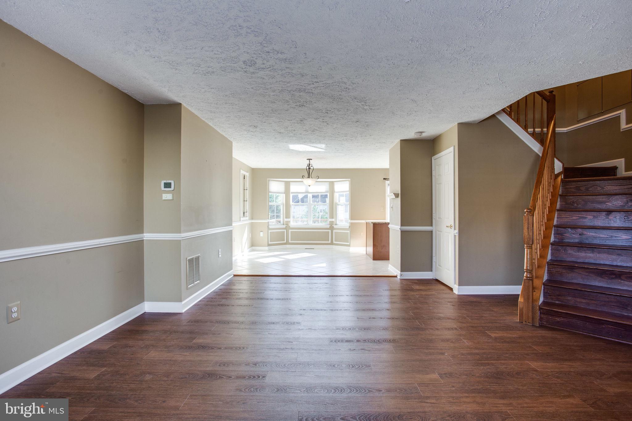 6121 Baldridge Circle Frederick, MD 21701 - Photo 59 of 60 a view of an empty room with wooden floor and a window