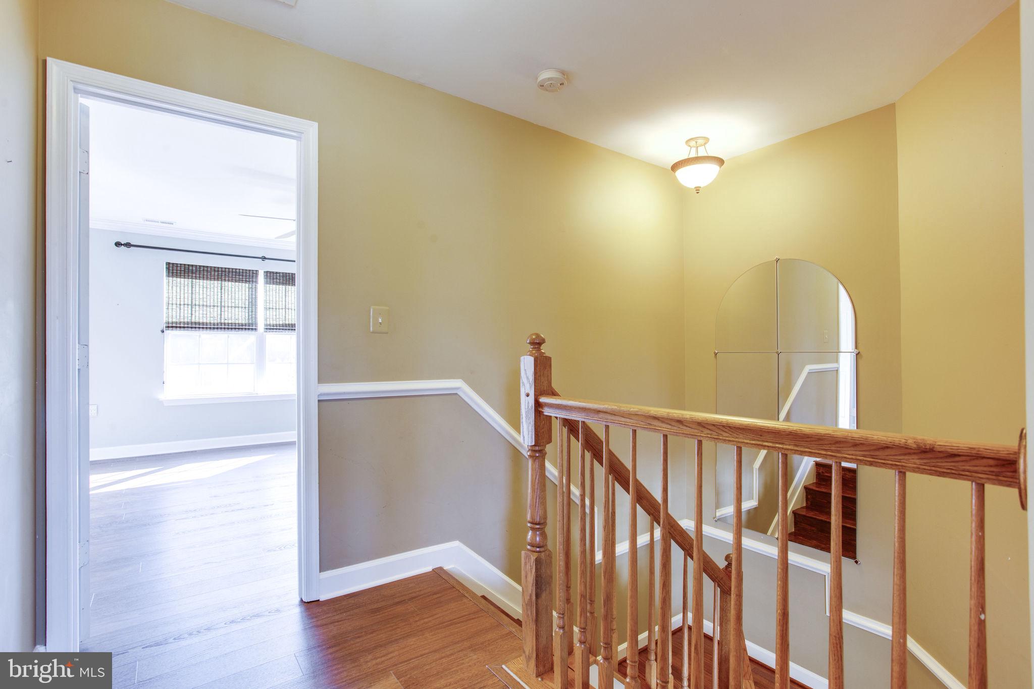 6121 Baldridge Circle Frederick, MD 21701 - Photo 40 of 60 a view of a hallway with wooden floor