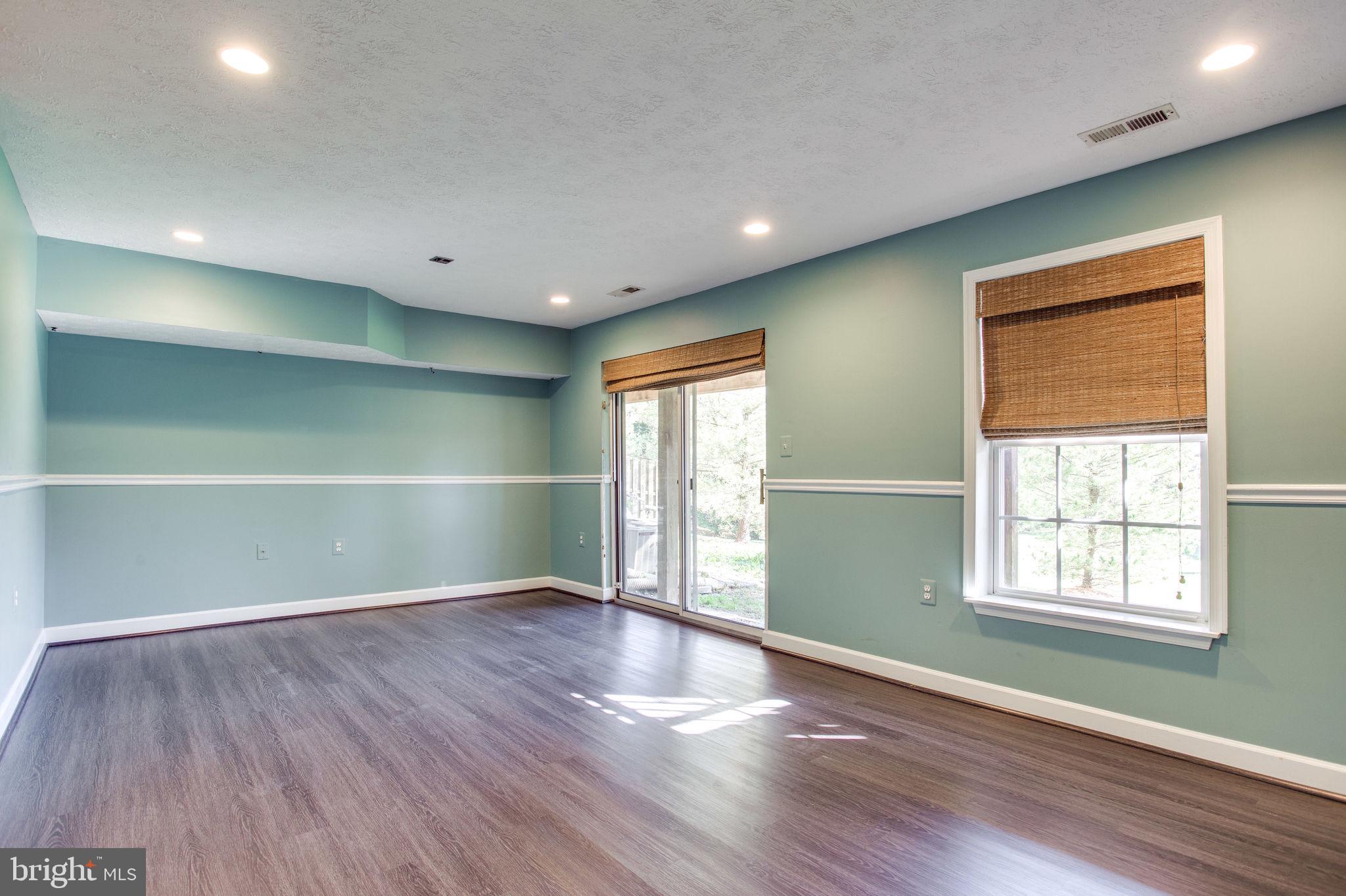 6121 Baldridge Circle Frederick, MD 21701 - Photo 44 of 60 an empty room with wooden floor and windows