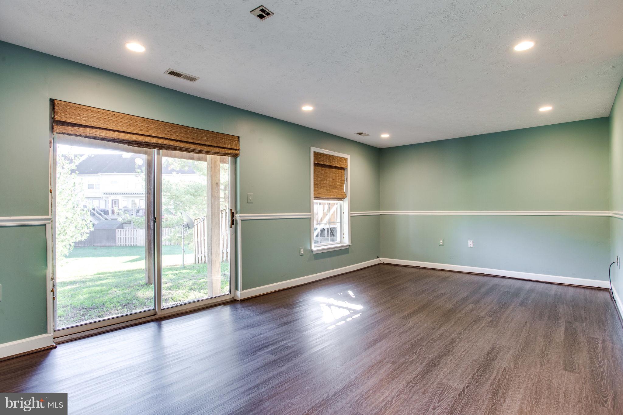 6121 Baldridge Circle Frederick, MD 21701 - Photo 47 of 60 a view of an empty room with wooden floor and a window