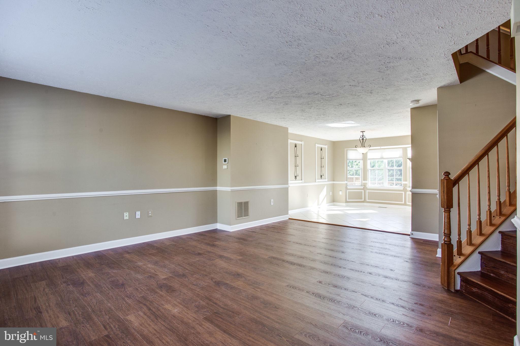 6121 Baldridge Circle Frederick, MD 21701 - Photo 5 of 60 a view of an empty room with wooden floor