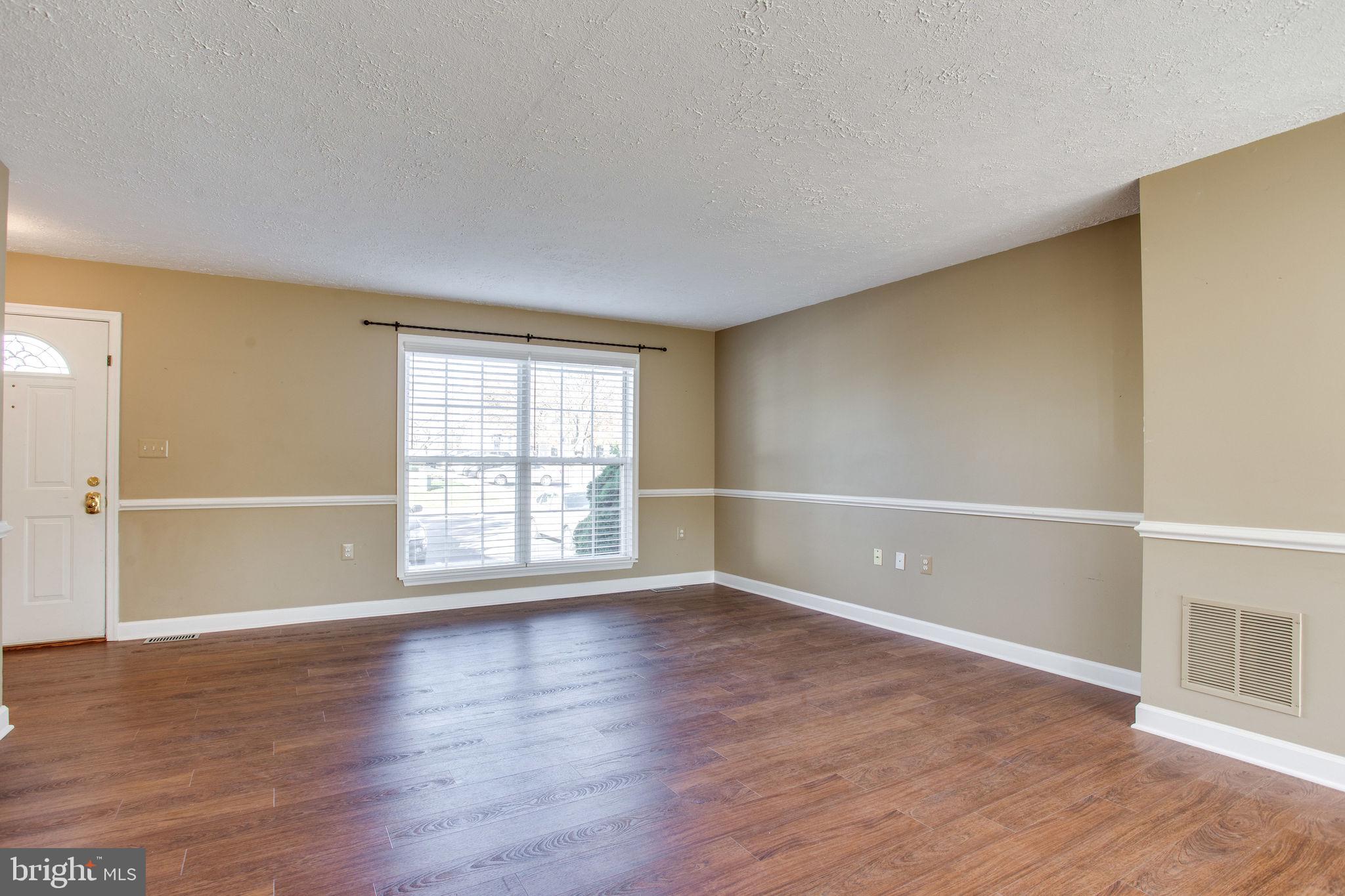 6121 Baldridge Circle Frederick, MD 21701 - Photo 6 of 60 an empty room with wooden floor and windows