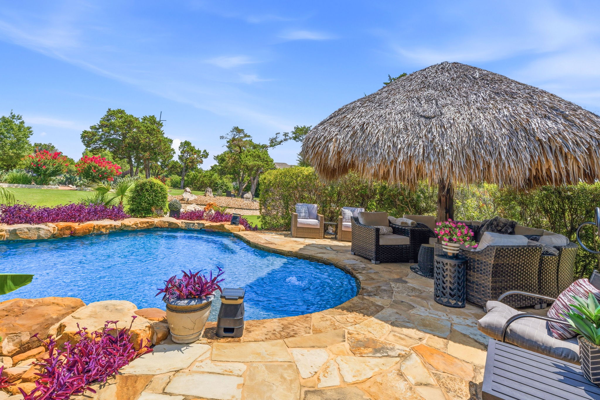 816 Brave Face Street Leander, TX 78641 - Photo 29 of 40 An inviting pool area with a thatched umbrella and comfortable seating creates an ideal outdoor retreat.