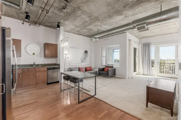 a living room with furniture a flat screen tv and a table