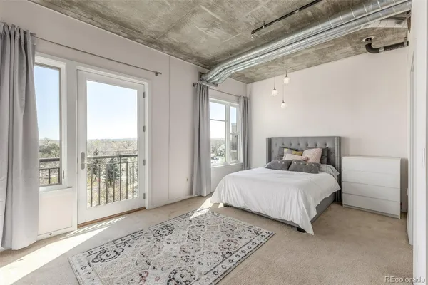 a bedroom with a large bed and a large window