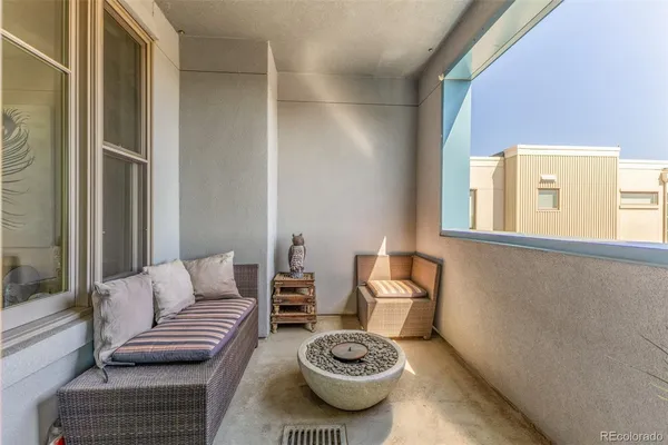 a living room with furniture a couch and a window