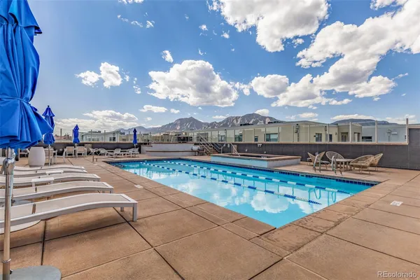 a view of a swimming pool with outdoor seating