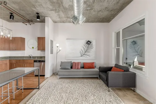 a living room with furniture and a rug