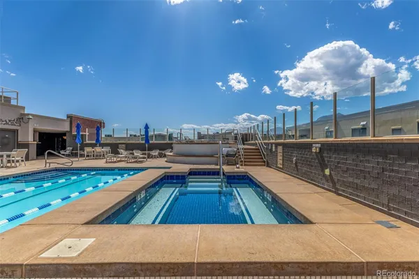 a swimming pool view with a sitting space