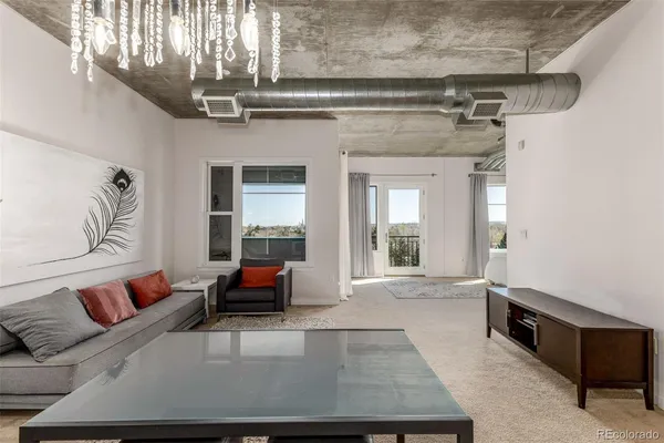 a living room with furniture and a chandelier