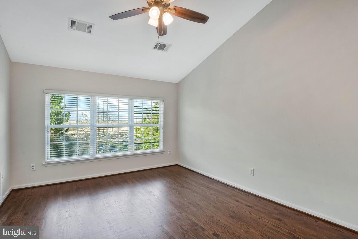 12025 Edgemere Circle Reston, VA 20190 - Photo 16 of 37 an empty room with wooden floor and windows