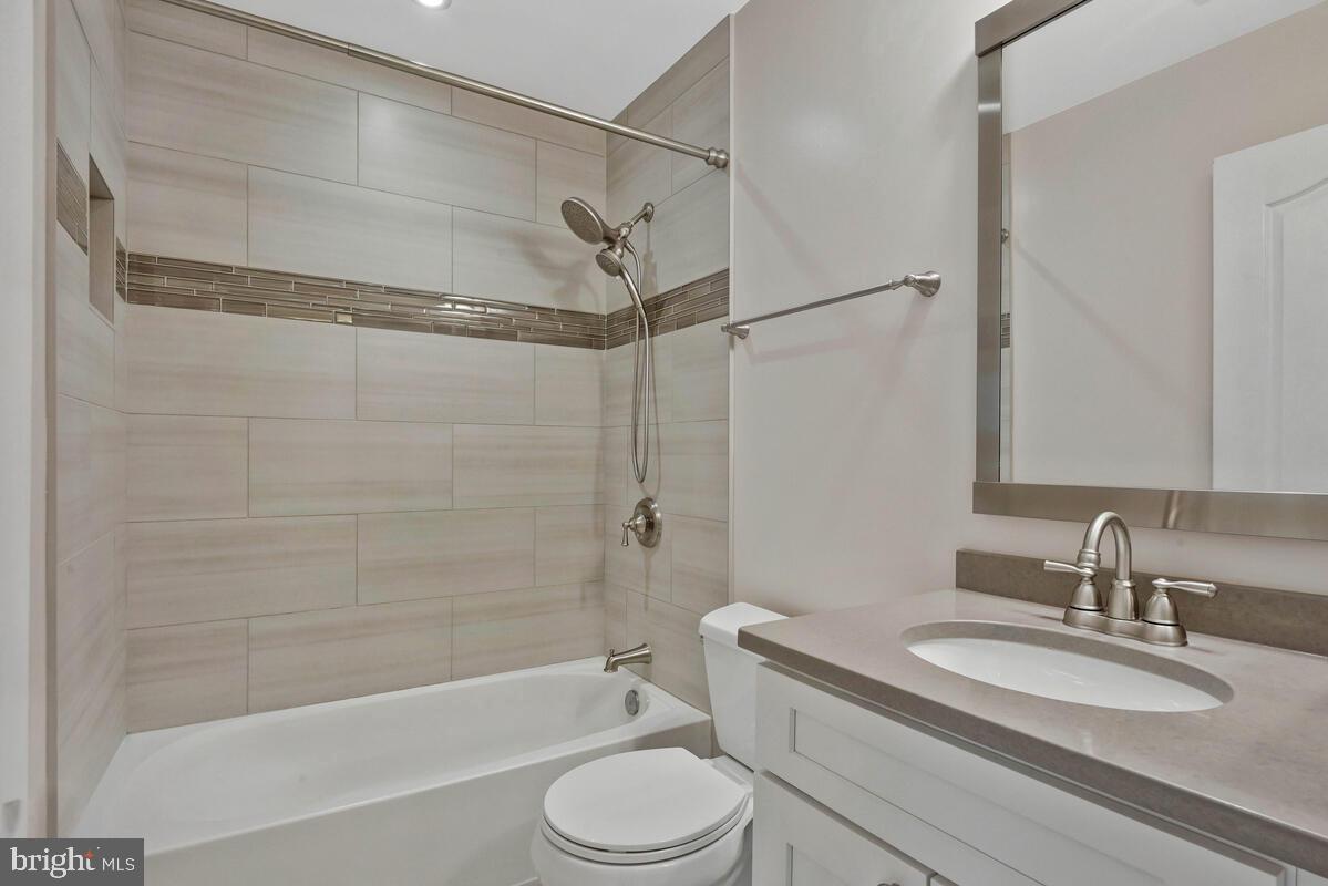12025 Edgemere Circle Reston, VA 20190 - Photo 22 of 37 a bathroom with a granite countertop sink toilet and shower