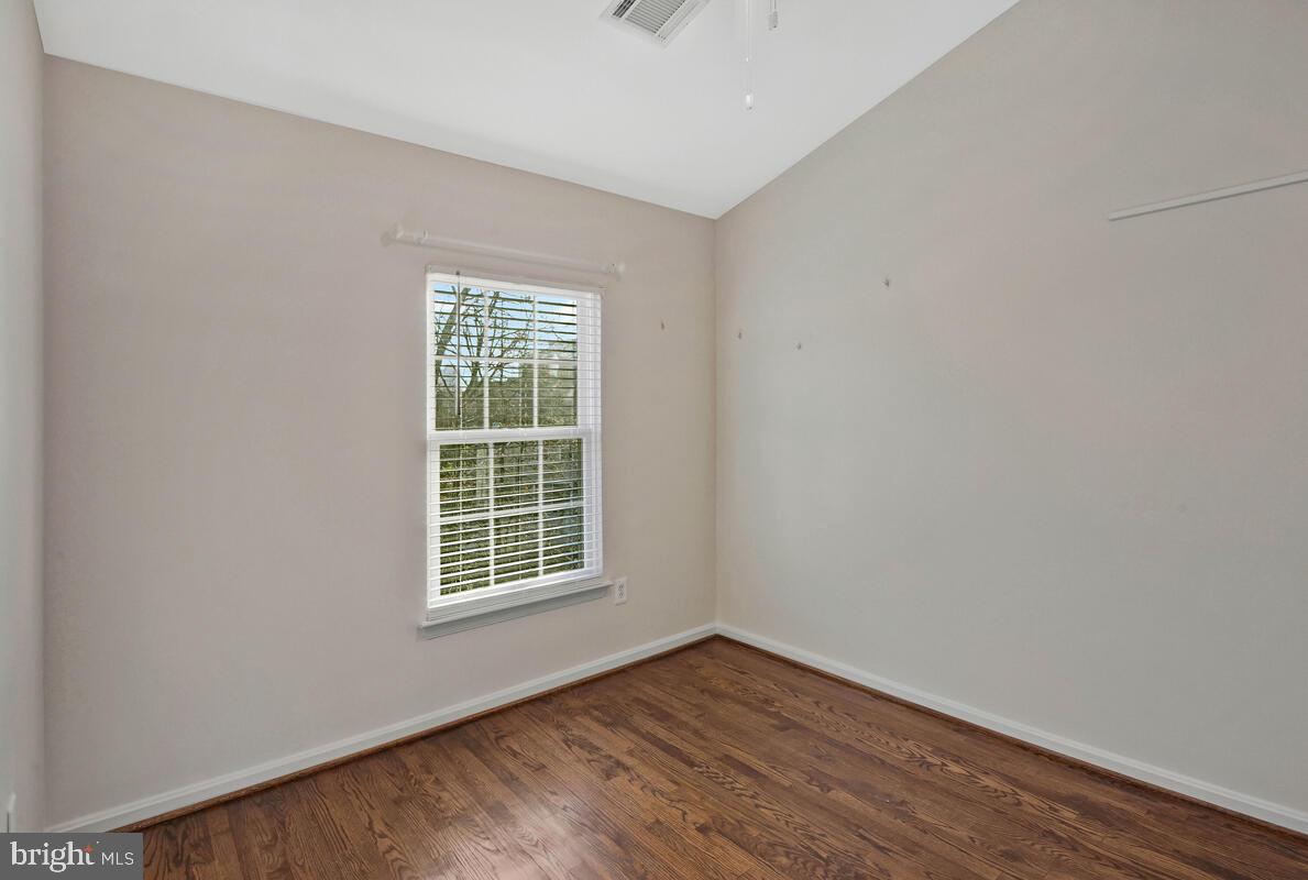12025 Edgemere Circle Reston, VA 20190 - Photo 23 of 37 a view of an empty room with wooden floor and a window