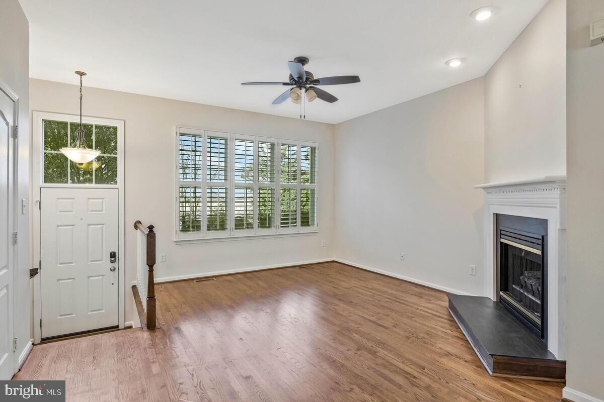 12025 Edgemere Circle Reston, VA 20190 - Photo 3 of 37 a view of an empty room with a window and wooden floor