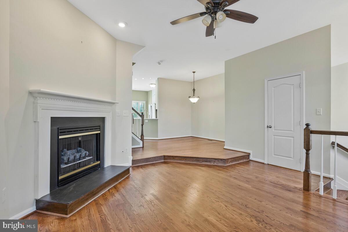 12025 Edgemere Circle Reston, VA 20190 - Photo 4 of 37 a living room with hard wood floors and a fireplace