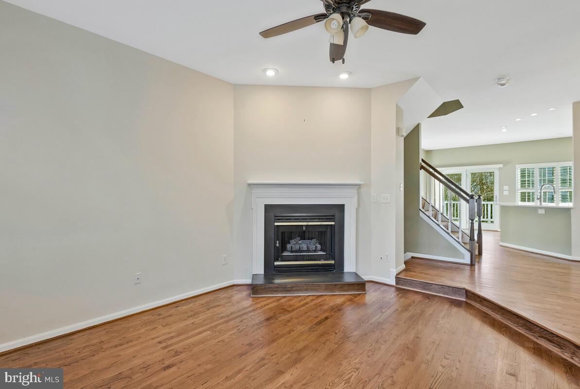 12025 Edgemere Circle Reston, VA 20190 - Photo 5 of 37 a view of an empty room with wooden floor fireplace and a window