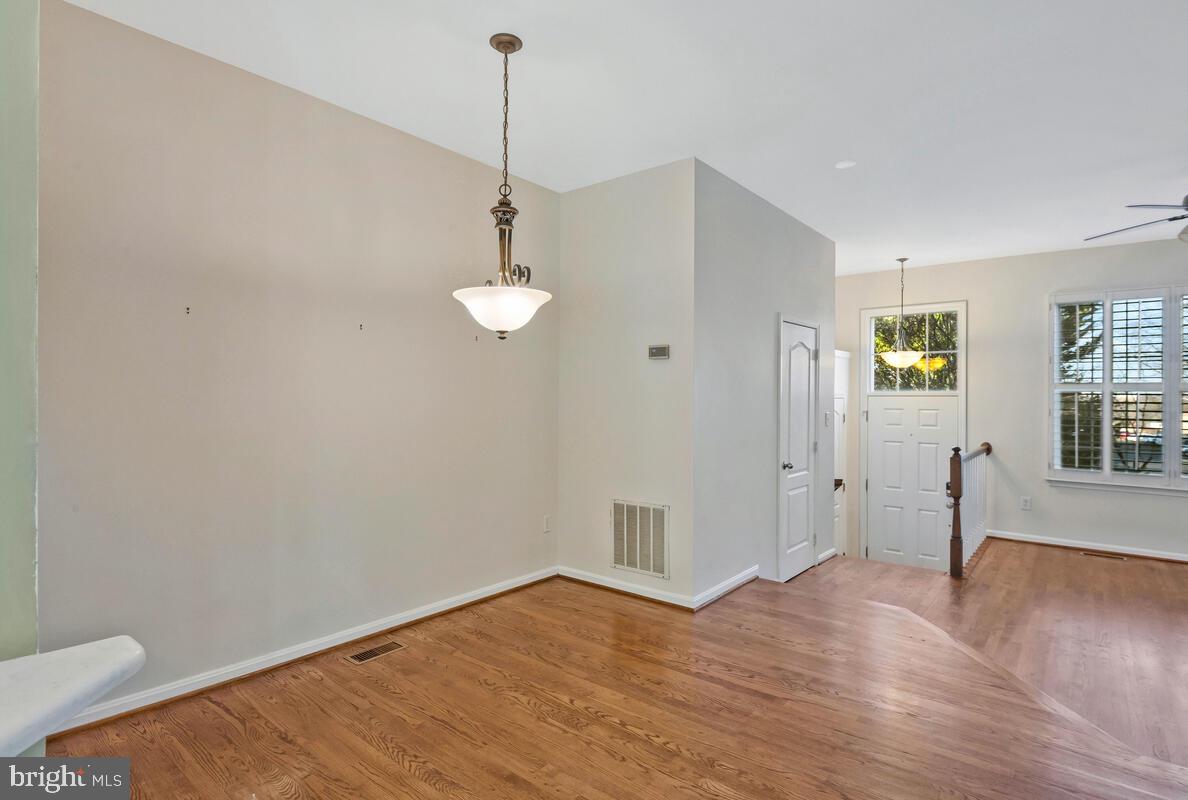 12025 Edgemere Circle Reston, VA 20190 - Photo 7 of 37 a view of an empty room with wooden floor and a window