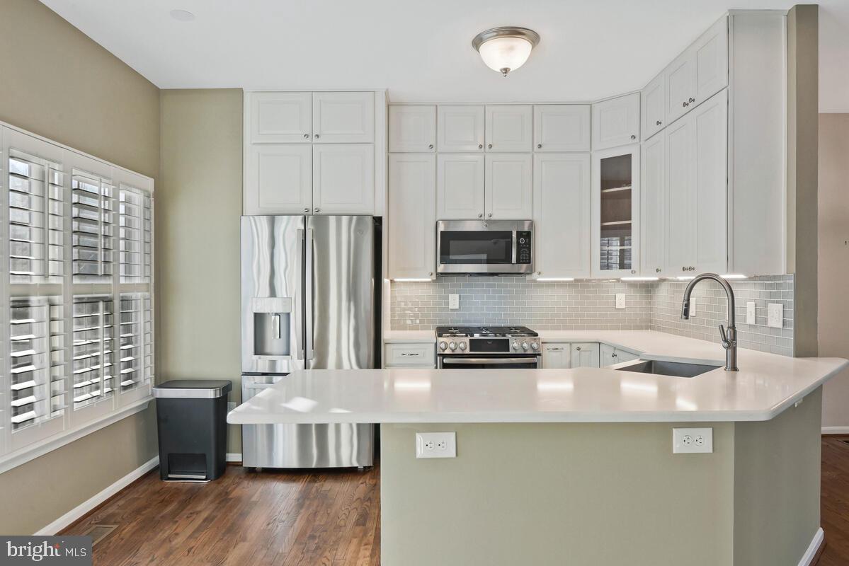 12025 Edgemere Circle Reston, VA 20190 - Photo 9 of 37 a kitchen with kitchen island granite countertop a sink cabinets and stainless steel appliances