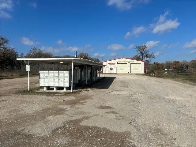 a view of a house with a patio and a yard