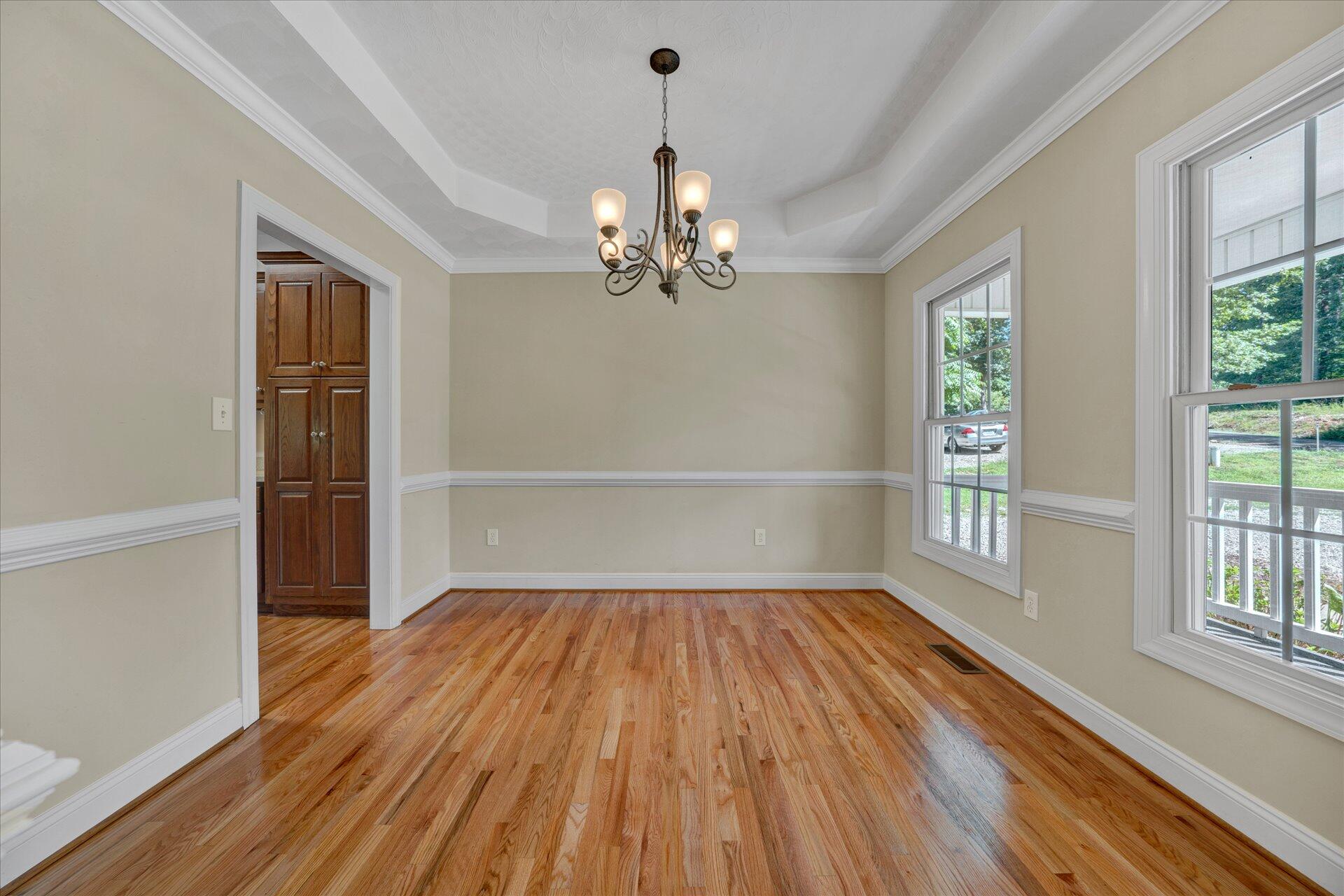5295 Horseshoe Bend Road Goodview, VA 24095 - Photo 4 of 35 wooden floor in an empty room with a window