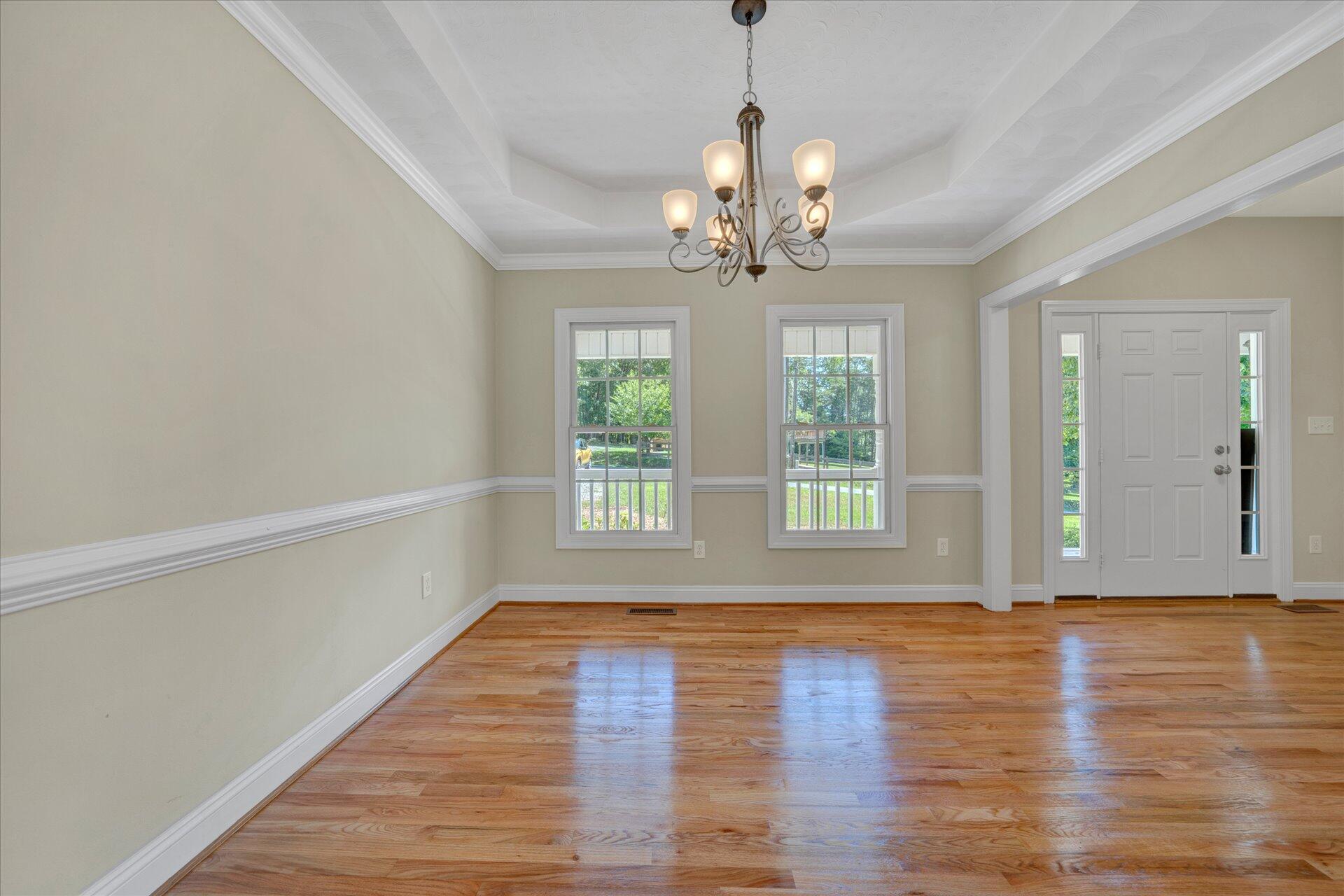 5295 Horseshoe Bend Road Goodview, VA 24095 - Photo 5 of 35 a view of livingroom with window wooden floor and chandelier