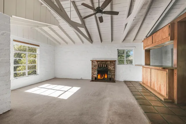 a kitchen with granite countertop white cabinets and a sink