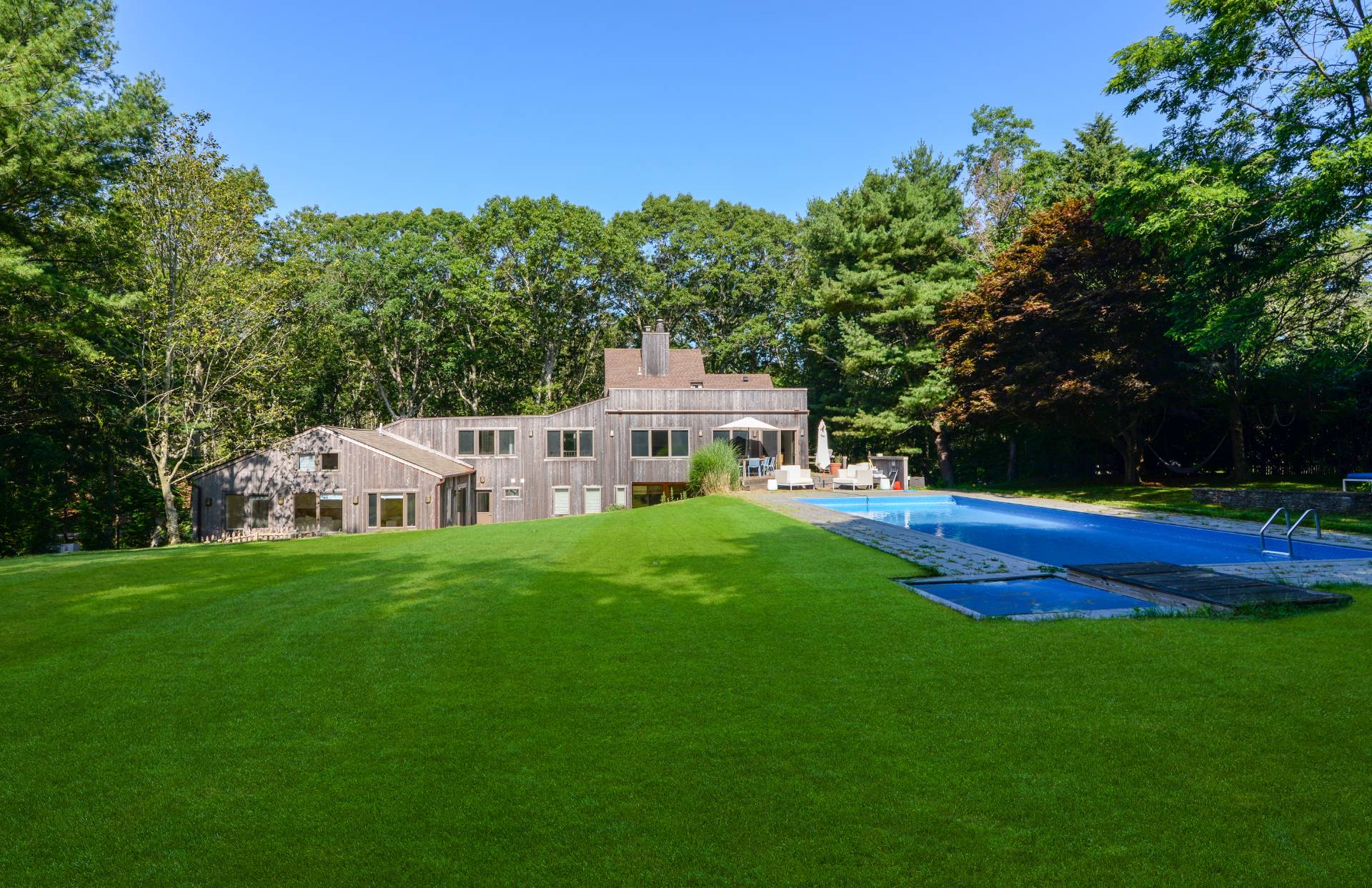 a front view of a house with a yard table and chairs