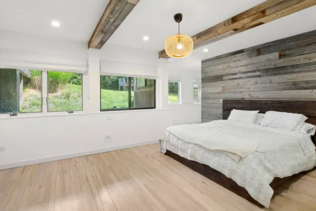 a bedroom with a large bed and a large window