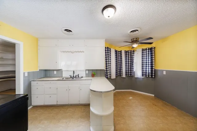 a bathroom with a granite countertop sink and a bathtub