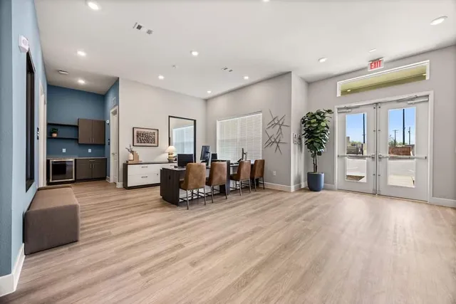 a large bedroom with furniture and large window