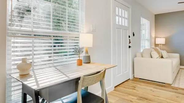 a dining room with furniture and wooden floor
