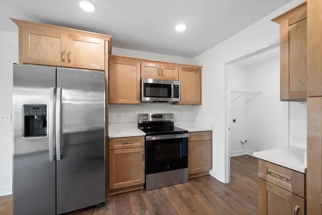 a kitchen with a refrigerator stove and microwave