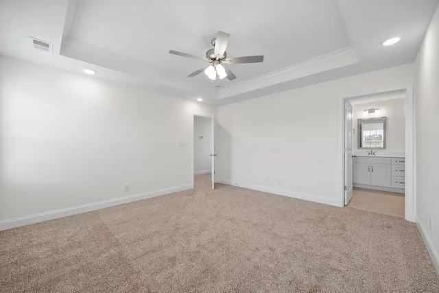 an empty room with closet and a chandelier fan
