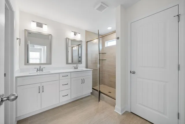 a bathroom with double sink and a mirror