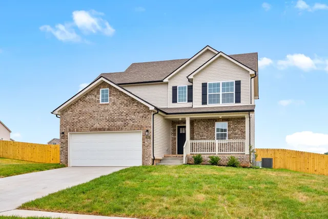 a front view of a house with a yard and garage