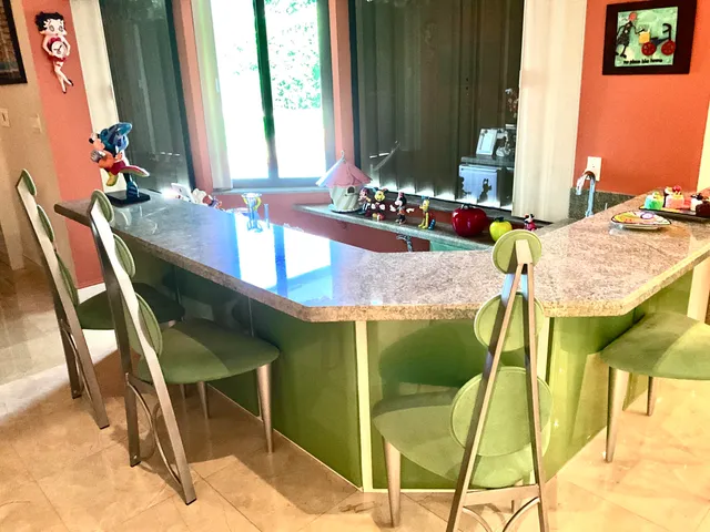 a very nice looking room with lots of fruit on the table and a rug