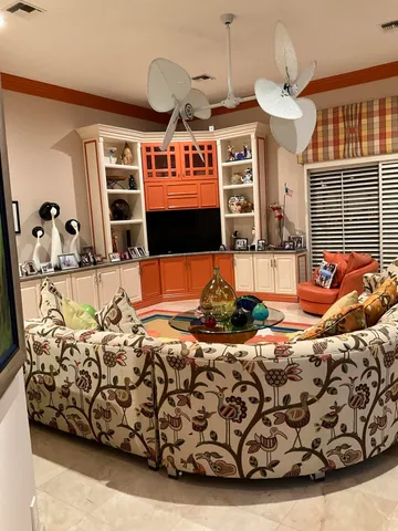 a bedroom with furniture and a large window