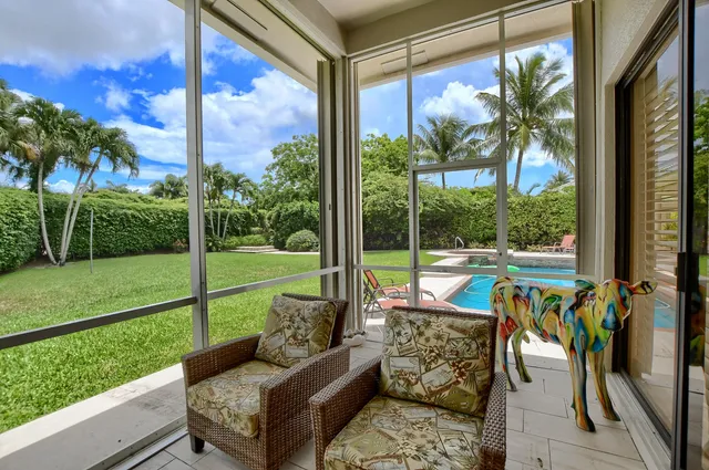 a view of a porch with furniture and garden