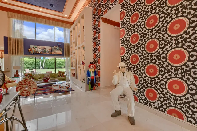 a living room with furniture and a floor to ceiling window