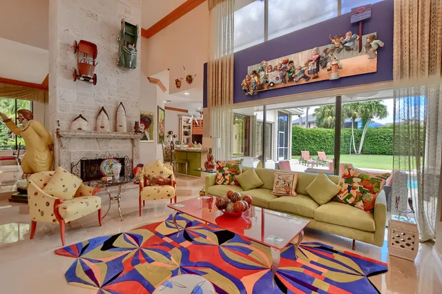 a kitchen with a sink dishwasher stove and chairs with wooden floor