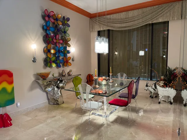 a dining room with furniture and window