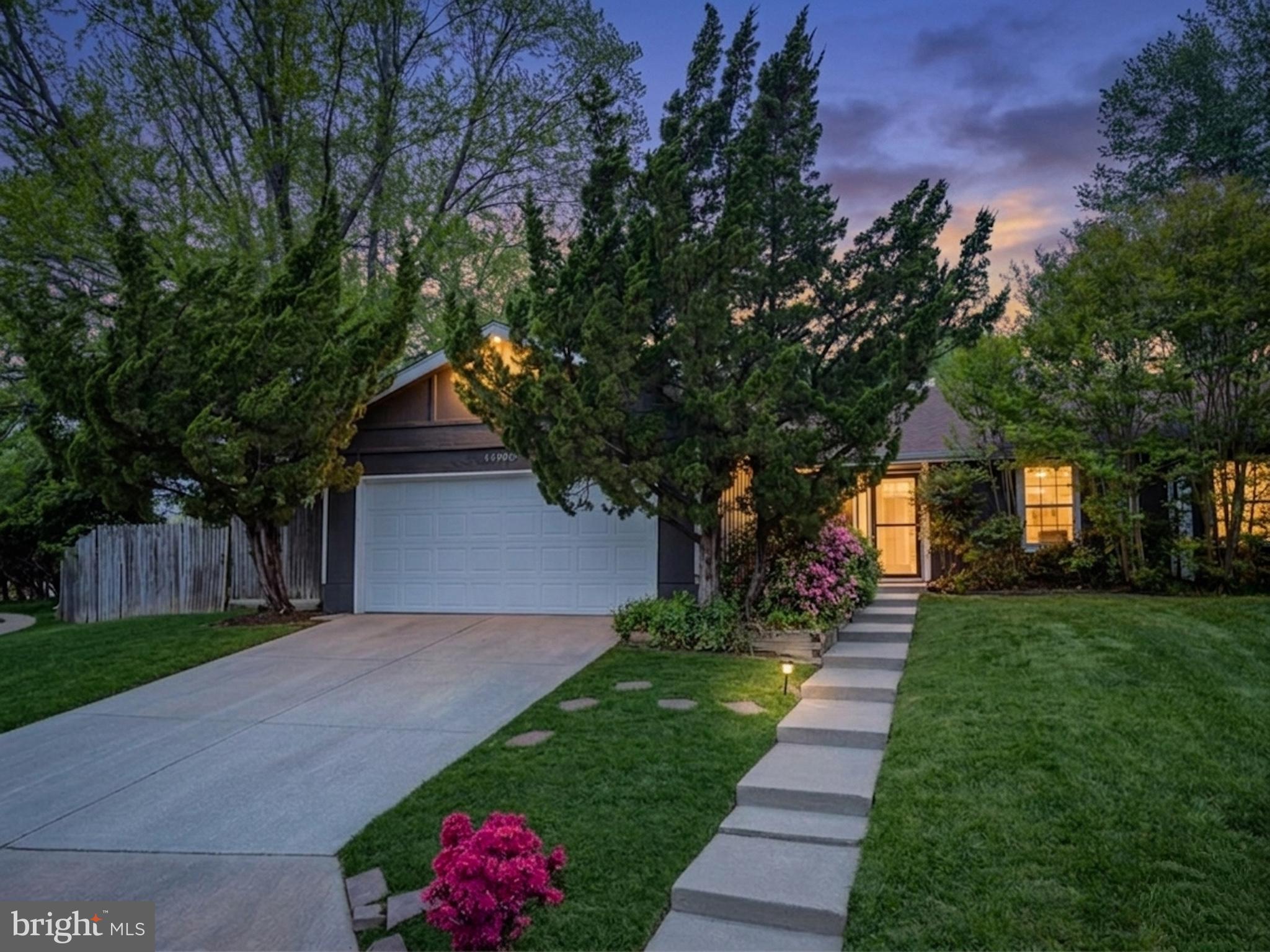 Charming home with lush landscaping.
