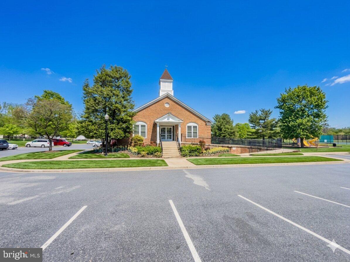14900 Hydrus Road Silver Spring, MD 20906 - Photo 27 of 30 Charming brick building under blue skies.