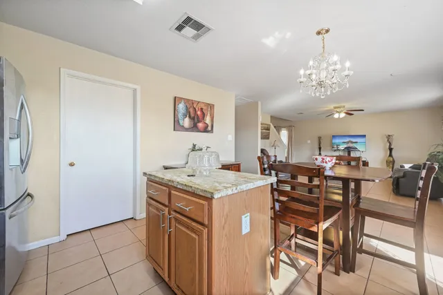 a view of a dining room with furniture and a chandelier