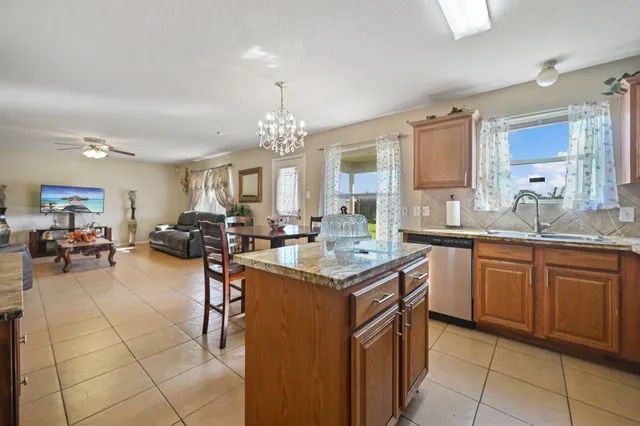 a kitchen with stainless steel appliances granite countertop a sink counter top space and cabinets
