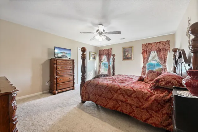 a bedroom with a bed dresser and a window